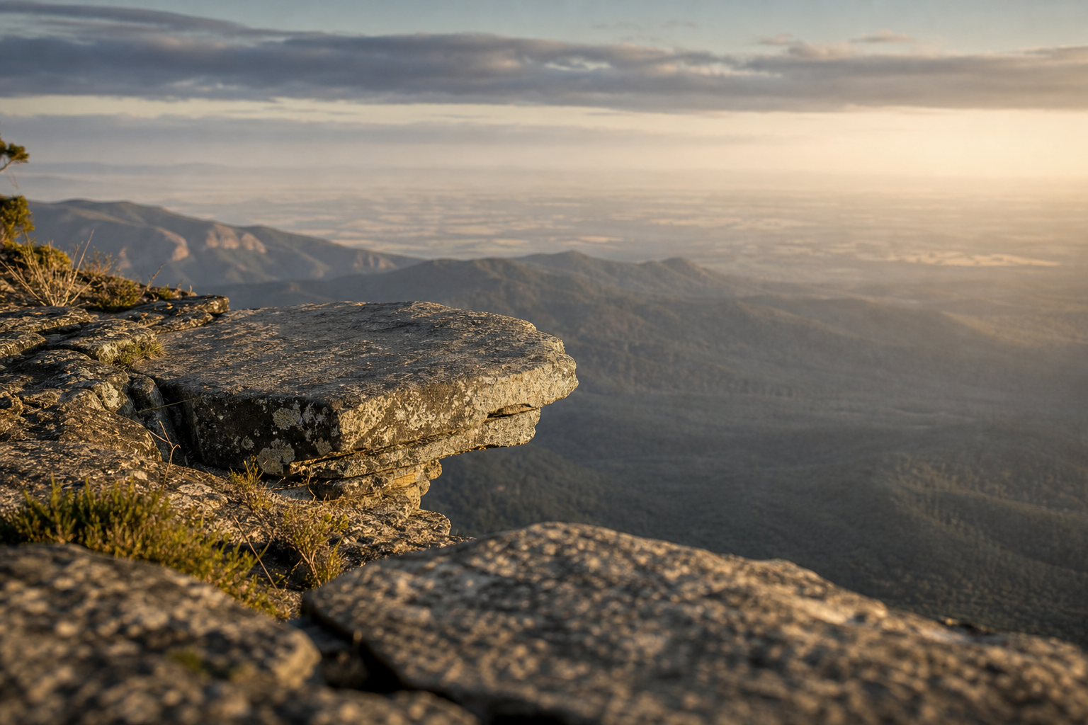 A natural stone ledge overlooking a valley, suggesting the right bench and strategic vantage point